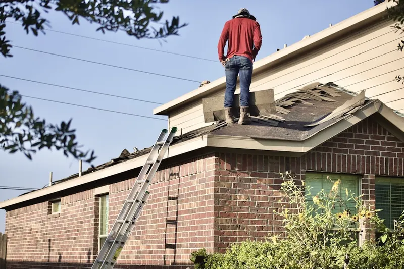 Professional roofer working on a residential roof in Kummer